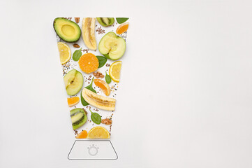 A blender filled with fresh whole fruits for making a smoothie or juice