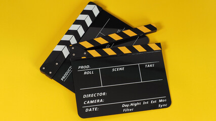 Two Black and yellow Clapper board or movie slate on yellow background.