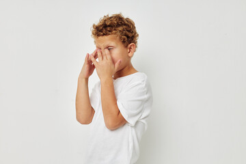 Cute little boy in a white t-shirt posing fun Lifestyle unaltered