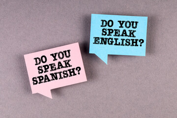 Learn and speak English and Spanish. Two speech bubbles on a gray background