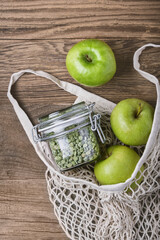Zero waste, plastic-free and eco-friendly lifestyle and shopping. Cotton mesh bag, products in glass jar and fresh fruits