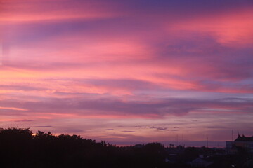 Cotton candy clouds on sunset sky landscape