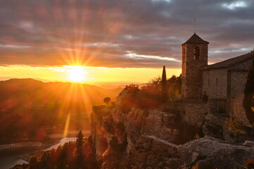Fototapeta premium View of the Romanesque church of Santa Maria de Siurana on the cliff at sunset, Siurana, Tarragona, Catalonia