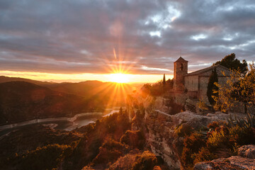 View of the Romanesque church of Santa Maria de Siurana on the cliff at sunset, Siurana, Tarragona,...