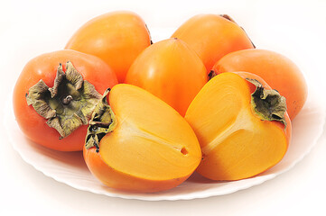 Fototapeta na wymiar orange persimmon on a white plate