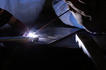 Welding of stainless steel by electric arc welding in argon shielding gas. TIG welding.
