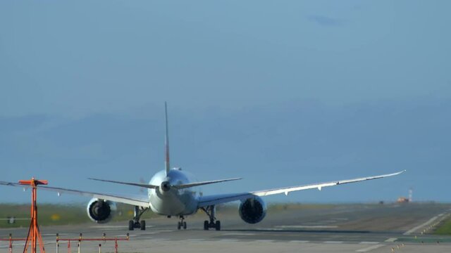 Rear Shot of a Boeing 787 Plane Rolling Down the Runway for Takeoff.