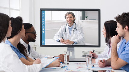 Team Of Diverse Doctors Having Online Meeting In Clinic Office