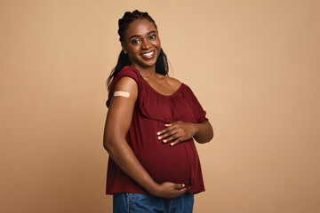 Cheerful pregnant black woman got vaccinated against COVID-19