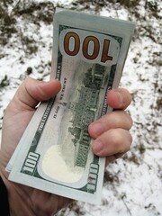 American hundred dollars lying in the hand