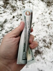 American hundred dollars lying in the hand