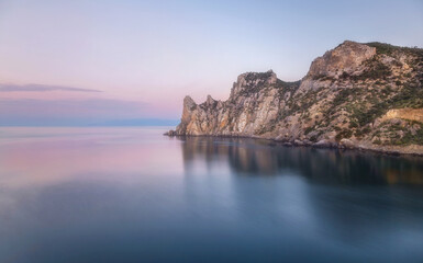 Fototapeta na wymiar Pastel and picturesque landscape on a mountain reflecting the sea in the morning light. Beauty of nature concept. Soft colors of the morning dawn. Crimea. 