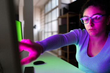 Businesswoman touching desktop screen at home office