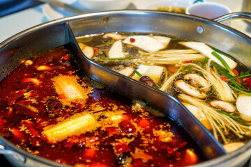 Close-up of the bottom of traditional Chinese Sichuan hot pot, two flavors
