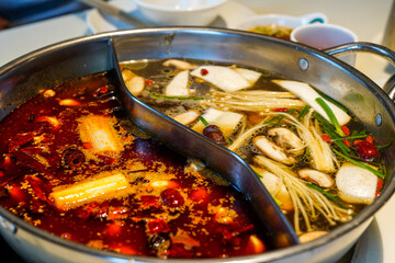 Close-up of the bottom of traditional Chinese Sichuan hot pot, two flavors - obrazy, fototapety, plakaty