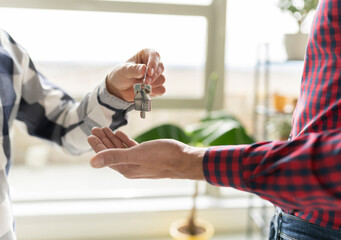Real estate agent giving house key to new home buyer