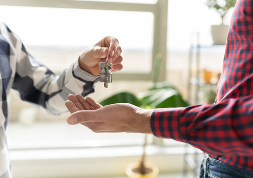 Real Estate Agent Giving House Key To New Home Buyer