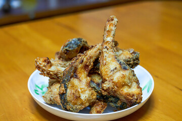A plate of delicious fried grass carp belly closeup
