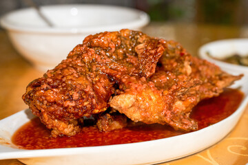 Traditional famous dish in Nanning, Guangxi, China, fried tilapia in sweet wine sauce