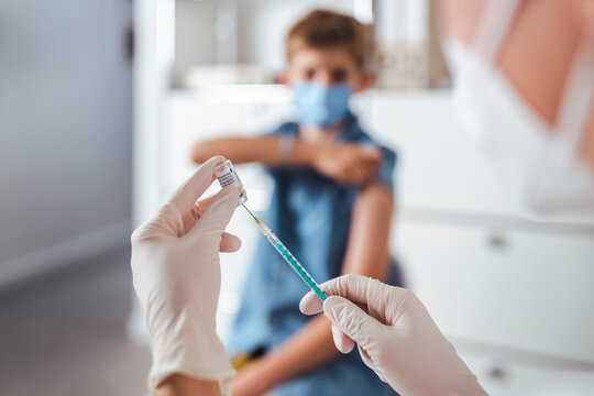 Nurse preparing injection at vaccination center