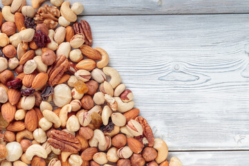 Top view of Mixed nuts on wooden table. Walnut, pistachios, almonds, hazelnuts and cashews.