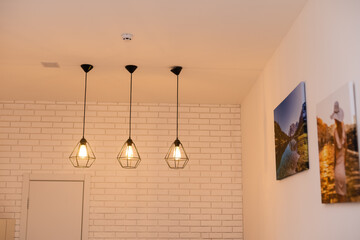 Vintage glowing light bulbs. Three hanging retro incandescent lamps.