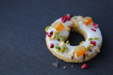 shortbread cookies with candied fruits on a dark background