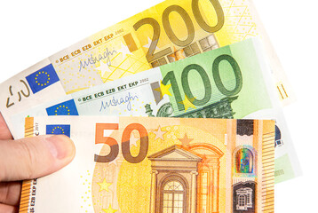 Banknotes of Euro currency in hand on white background