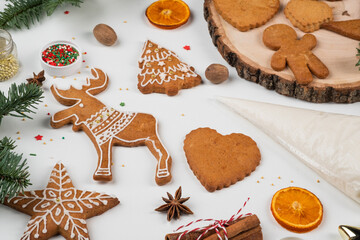 Christmas preparations. Hands decorate handmade Christmas gingerbread with glaze, icing sugar. Female hands paint Christmas gingerbread cookies.
