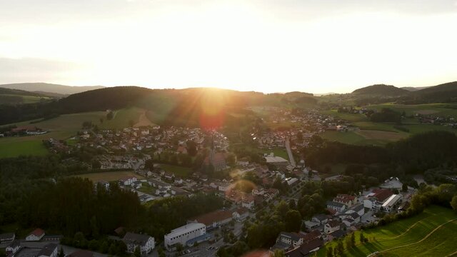 Drone flight in the Bavarian Forest, Lower Bavaria, Bavaria, Germany, Europe
Sunset behind the mountains and a small village in the foreground
