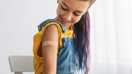 Fototapeta Happy Vaccinated Teen Girl Showing Shoulder After Shot obraz