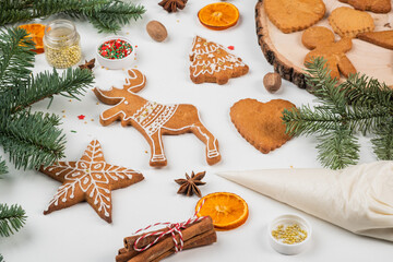Fototapeta na wymiar Christmas preparations. Hands decorate handmade Christmas gingerbread with glaze, icing sugar. Female hands paint Christmas gingerbread cookies.