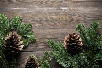 New Year's background. Christmas tree with cones on a dark wooden background. Copy space. Flat lay.Ornaments for the New Year tree. Christmas concept.