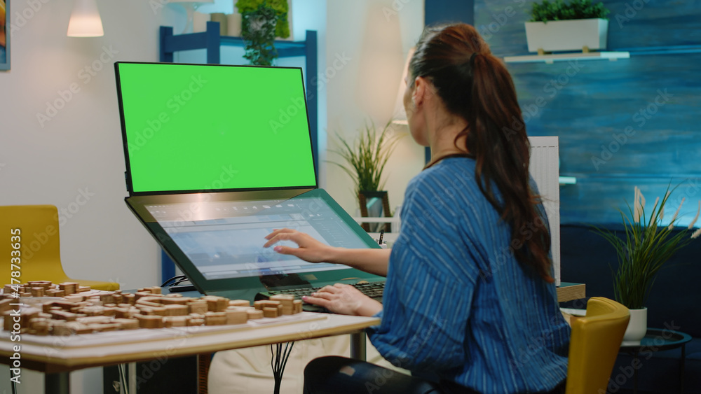 Poster architect looking at horizontal green screen for building model on touch screen computer. woman engi
