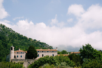 Fototapeta na wymiar Podmaine monastery surrounded by mountains. Budva, Montenegro