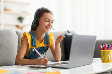 Online Education. Girl using laptop, talking during videocall