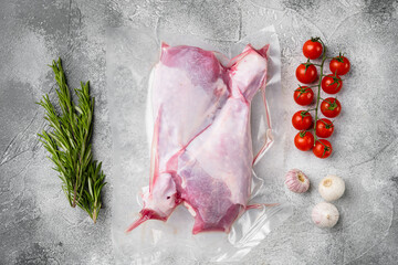 Raw turkey thigh vacuum pack, top view flat lay, on gray stone table background