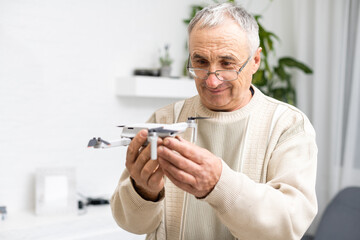 elderly man with small model airplane