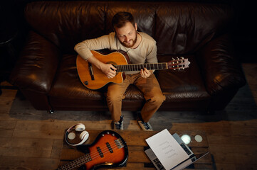Guitarist learning song playing guitar overhead view