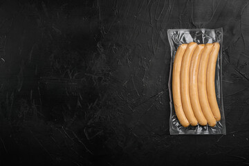 Fototapeta Packing sausages, on black dark stone table background, top view flat lay, with copy space for text obraz