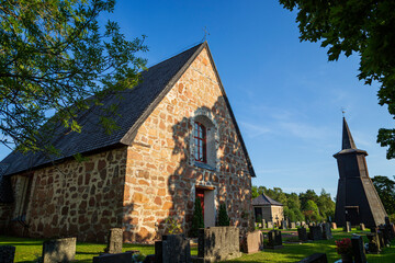 Fototapeta na wymiar Geta church (Saint George's chapel church) and cemetery in Geta, Åland Islands, Finland, on a sunny day in the summer. It's believed to be built in the 1460's.