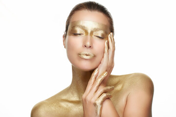 Skin care. Young woman with clean fresh skin touching her healthy facial skin. Gold skincare...