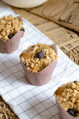 Delicious crumble blueberry muffins cupcake on white cafe table.