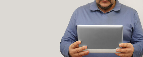 Detail of bearded man using gray tablet computer. isolated on white background. no face.