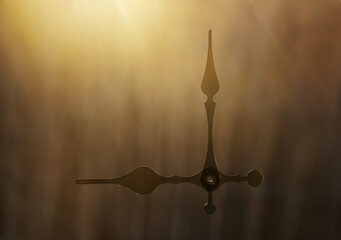 clock hands in front on sunny morgen sky background. clock on spring or summer landscape. wake up....
