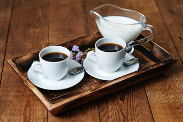 Two espresso cups on a wooden table. Morning coffee. Breakfast with coffee. Wooden table.