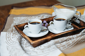 Two espresso cups on a wooden table. Morning coffee. Breakfast with coffee. Wooden table.