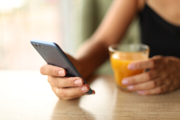 a girl is sitting in a cafe with freshly squeezed juice and a phone
