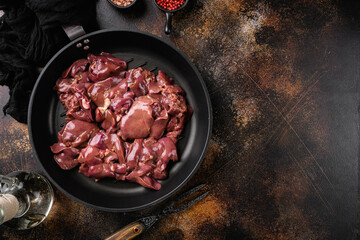 Raw chicken liver, on old dark rustic table background, top view flat lay, with copy space for text