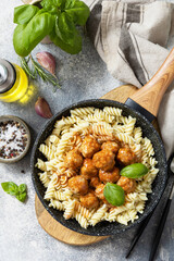 Italian  kitchen. Italian fusilli pasta with meat balls in tomato sauce and basil on grey stone background. Flat lay, top view.
